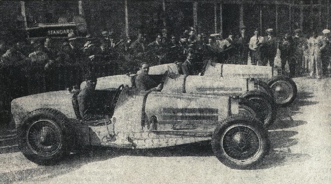 Newspaper photograph of three Bugatti Type 59 racing cars lined up side by side in front of a crowd