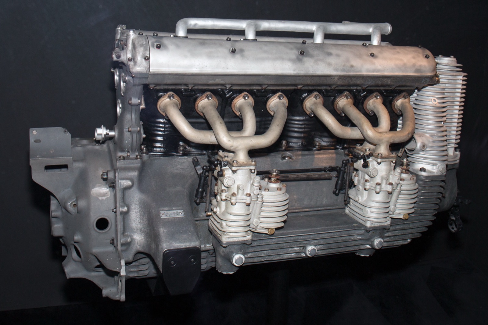 A Mercedes-Benz M 25 E straight-eight racing engine on a stand, showing its inlet manifolds and carburettors