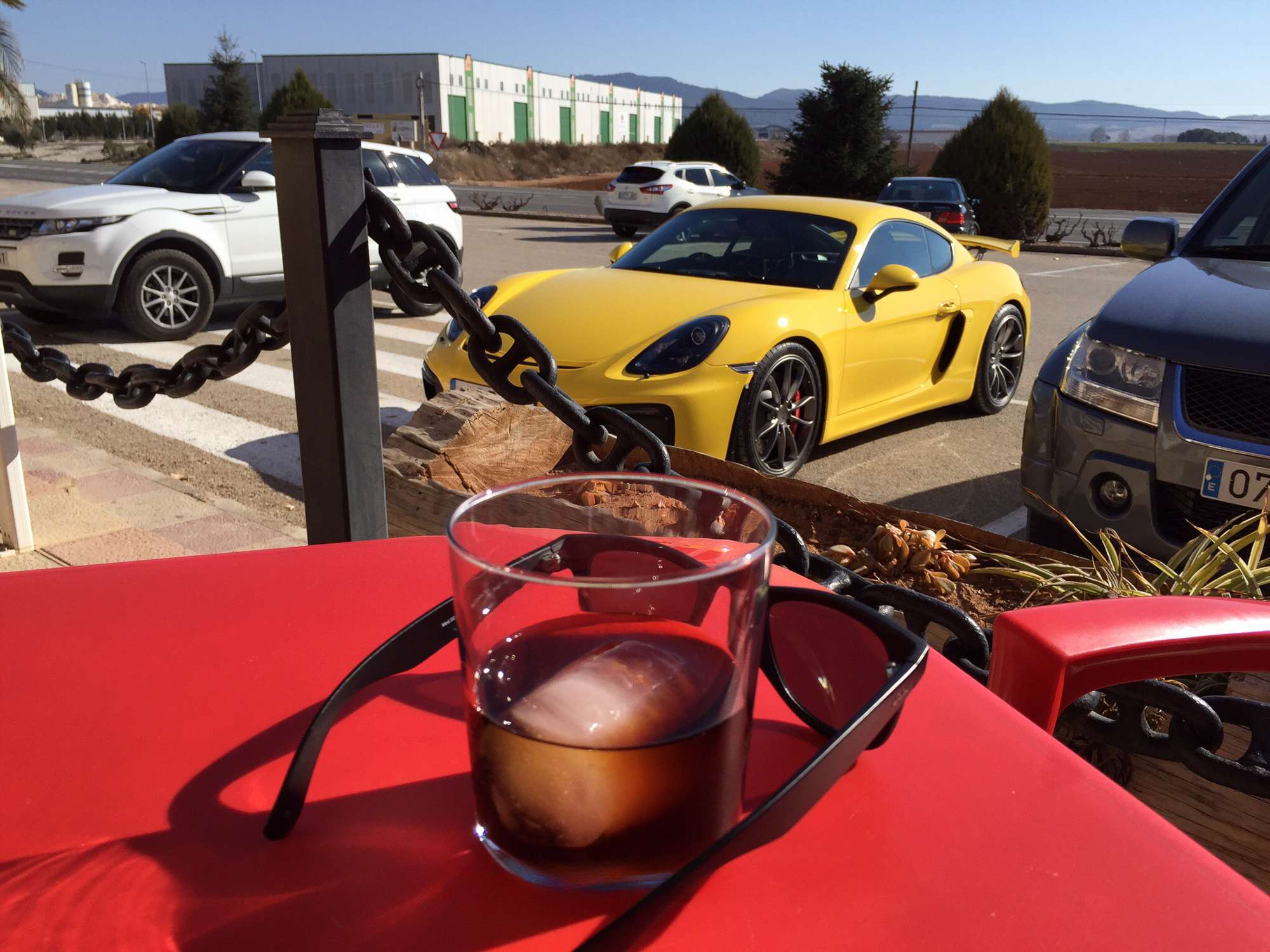Perfect road trip cocktail. Cayman GT4, some shades and a cold drink